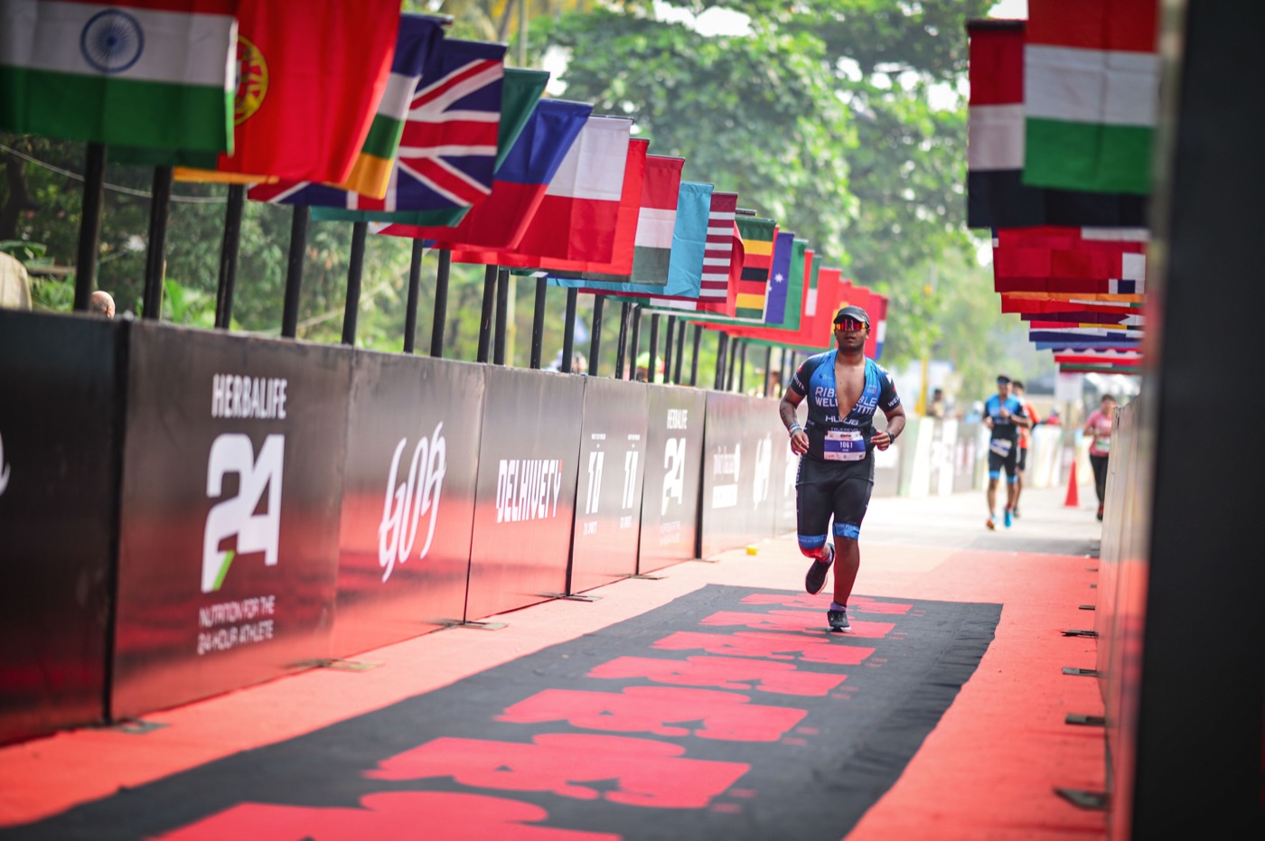 Anjan running down the finish chute with international flags