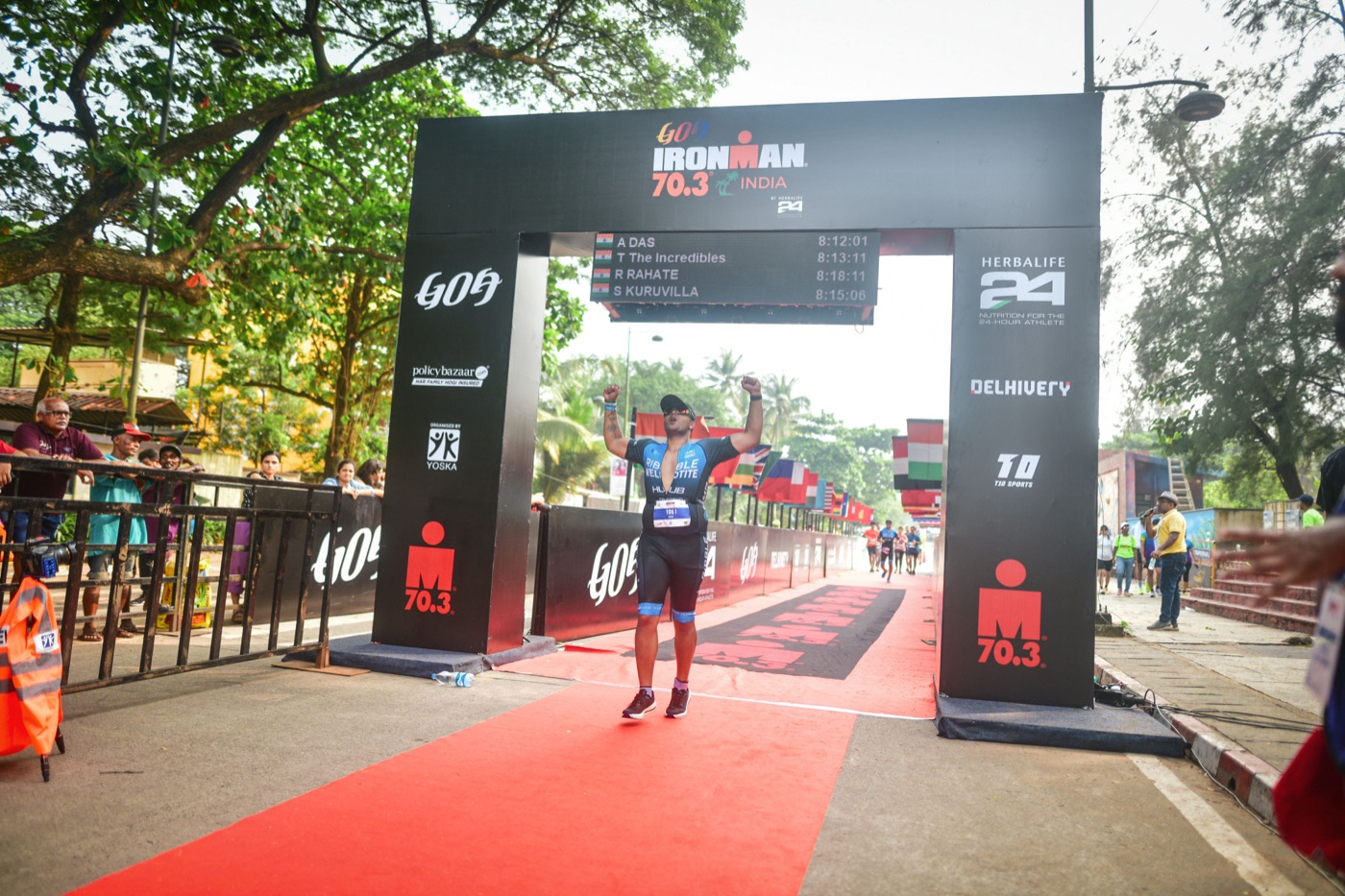 Anjan Das at Ironman 70.3 India finish line, arms raised
