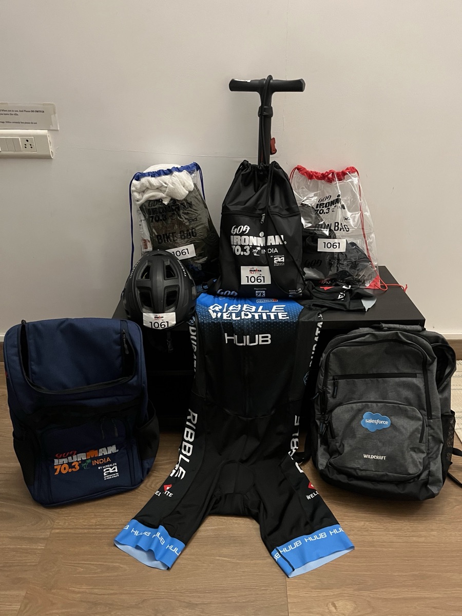 Pre-race transition kit — helmet, tri-suit, bags, bib 1061