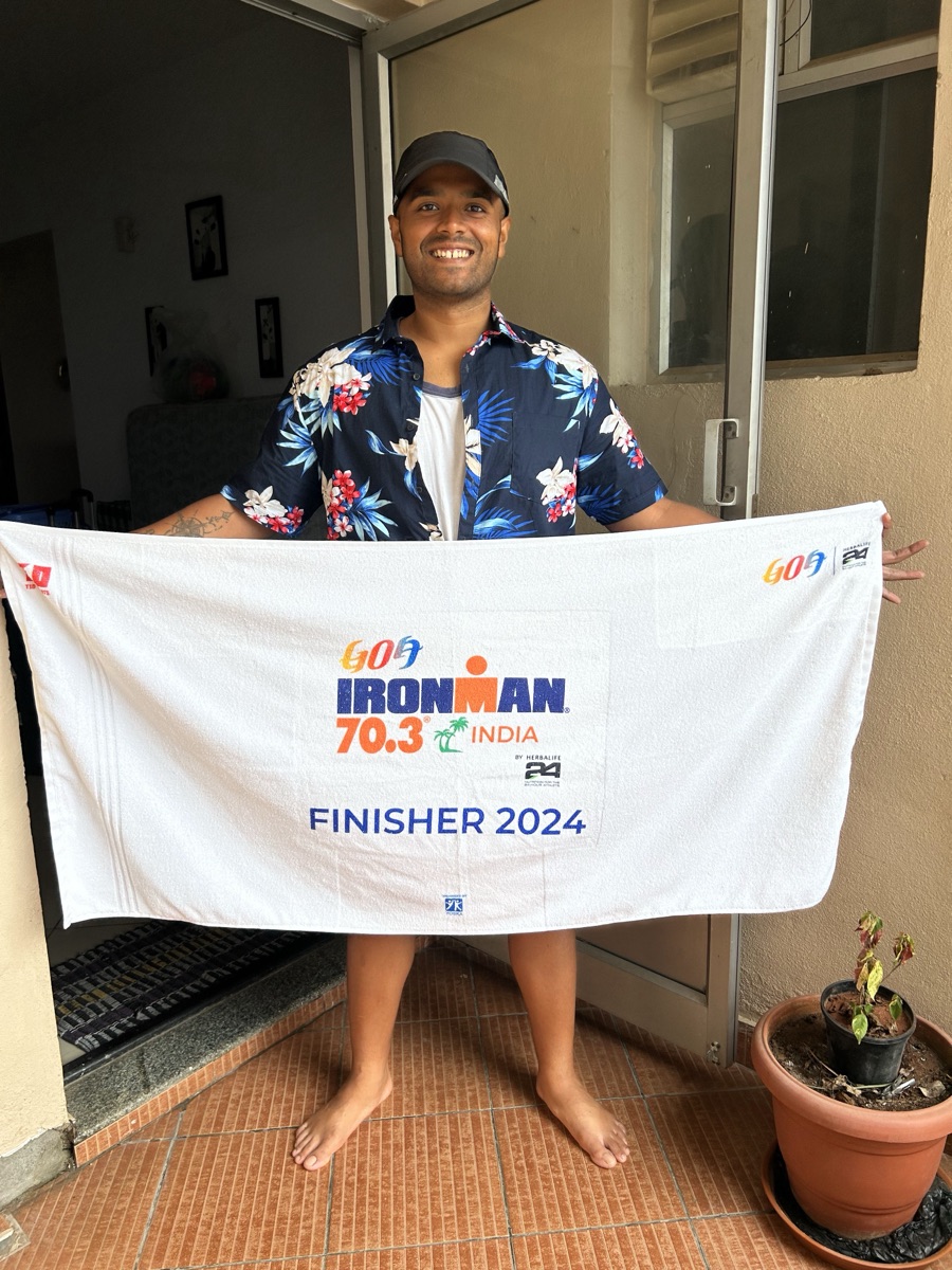 Anjan holding the Ironman 70.3 India FINISHER 2024 towel